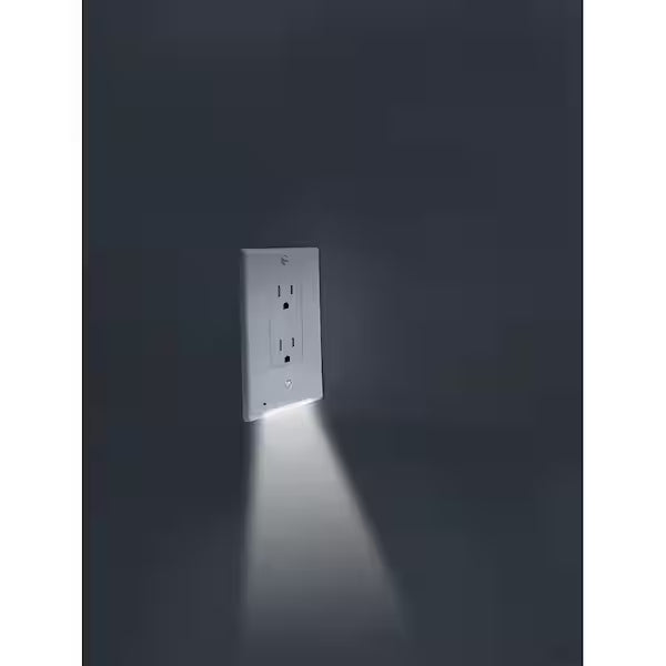 Wall outlet with built-in LED light on a dark background