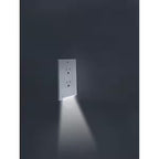 Wall outlet with built-in LED light on a dark background